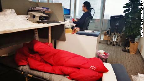 I commercianti dormono accanto alle loro scrivanie mentre il centro finanziario cinese è chiuso