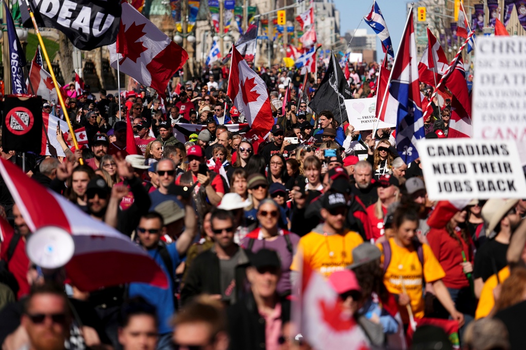 I manifestanti raccolgono e sventolano bandiere durante una manifestazione il 30 aprile 2022.