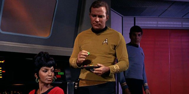 Nichelle Nichols (nel ruolo del tenente Nyota Uhura) e William Shatner (nel ruolo del capitano James T. Kirk) sono mostrati in una scena di "trappola per uomini" Il primo episodio di "Star Trek" trasmesso l'8 settembre 1966.
