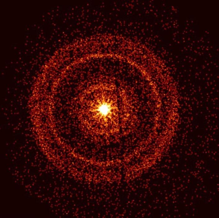 I raggi gamma giallo brillante esplosero circondati da anelli di punti rossi